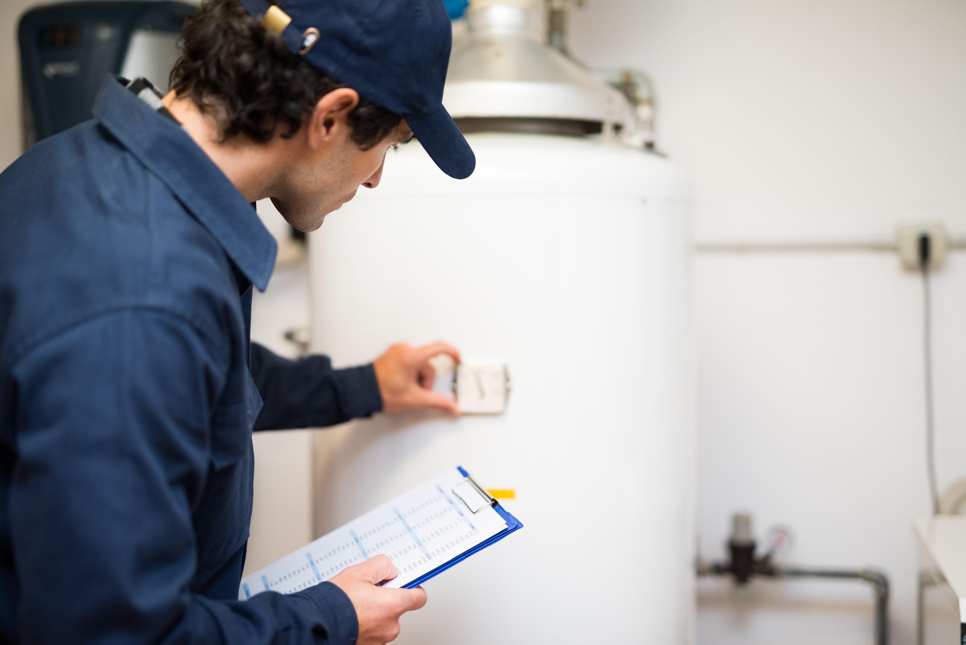 plumber checking water heater for issues